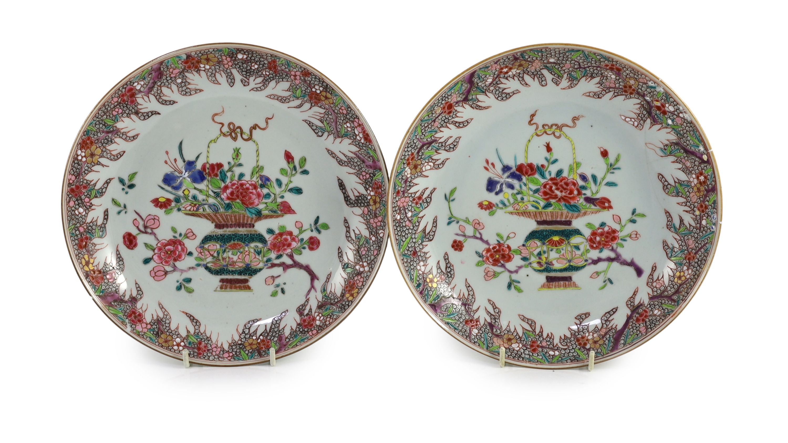 A pair of Chinese famille rose dishes, early Qianlong period, 22 cm diameter, one broken and repaired